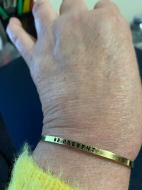 Gold 'Be Present' Stamped Cuff Bracelet. Signed but unsure what signature says